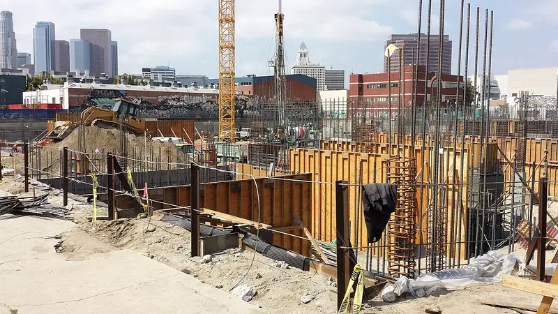 Concrete and rebar on an Arts District construction site with the downtown Los Angeles skyline behind it