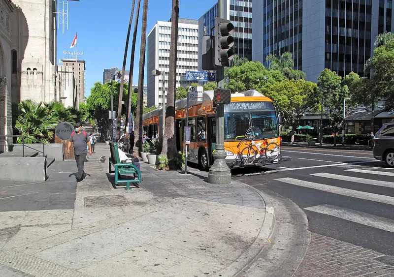 Wilshire Boulevard at Normandie with a Metro bus and mid-rise buildings