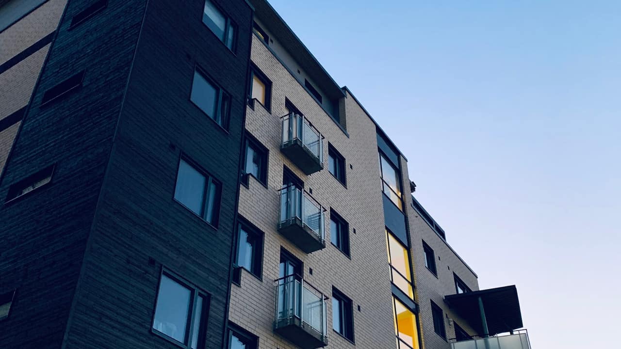 A new mid-rise apartment building against a blue sky