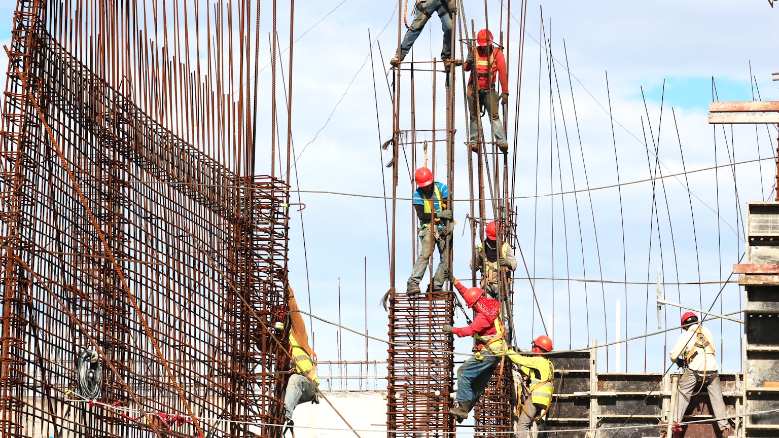 Workers on rebar cages at a large construction site