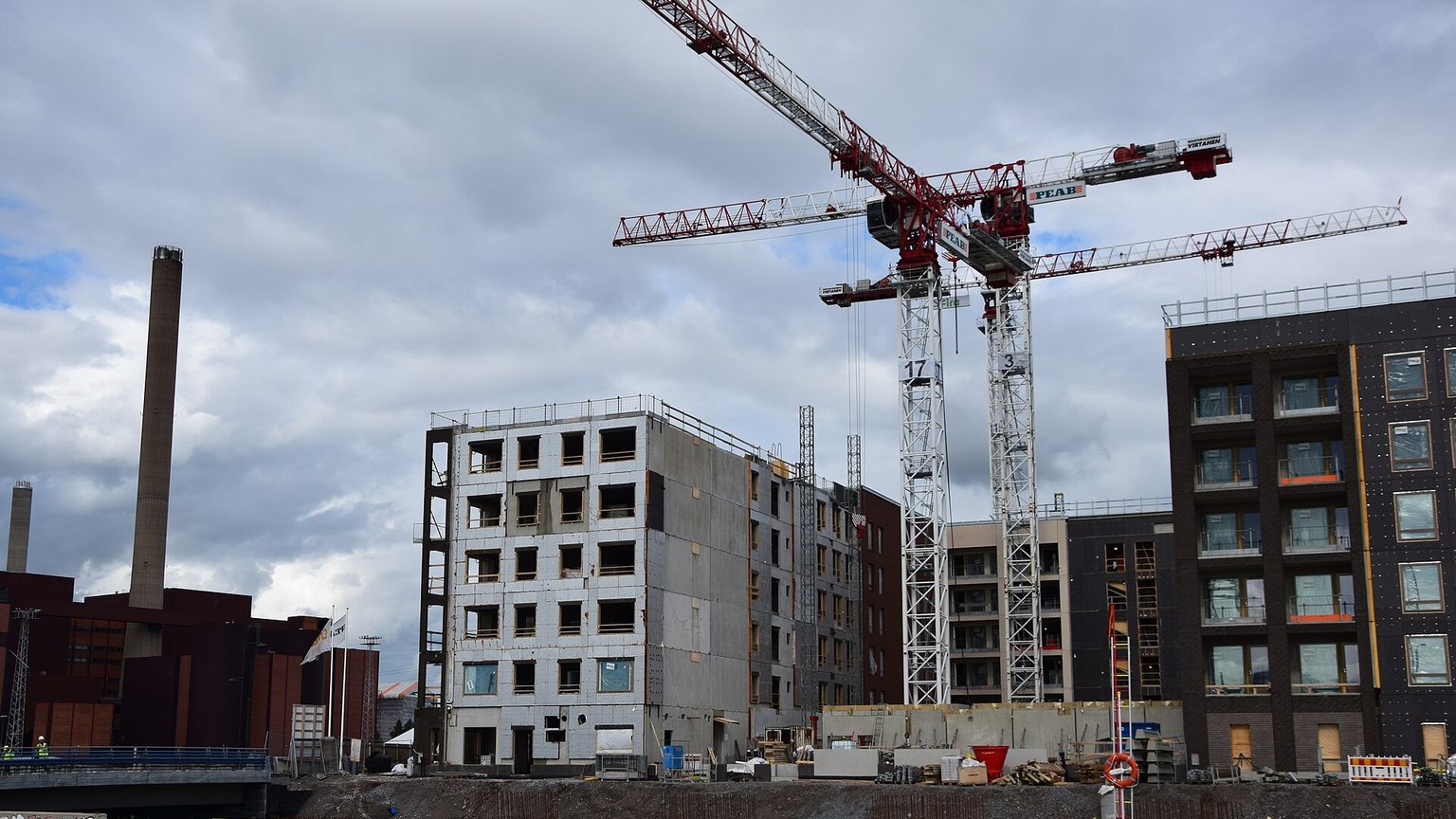 Residential development under construction with tower cranes on the skyline