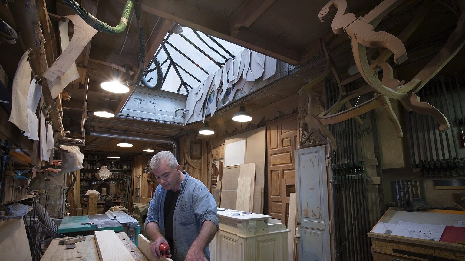 Cabinetmaker assembling custom cabinetry in a millwork shop