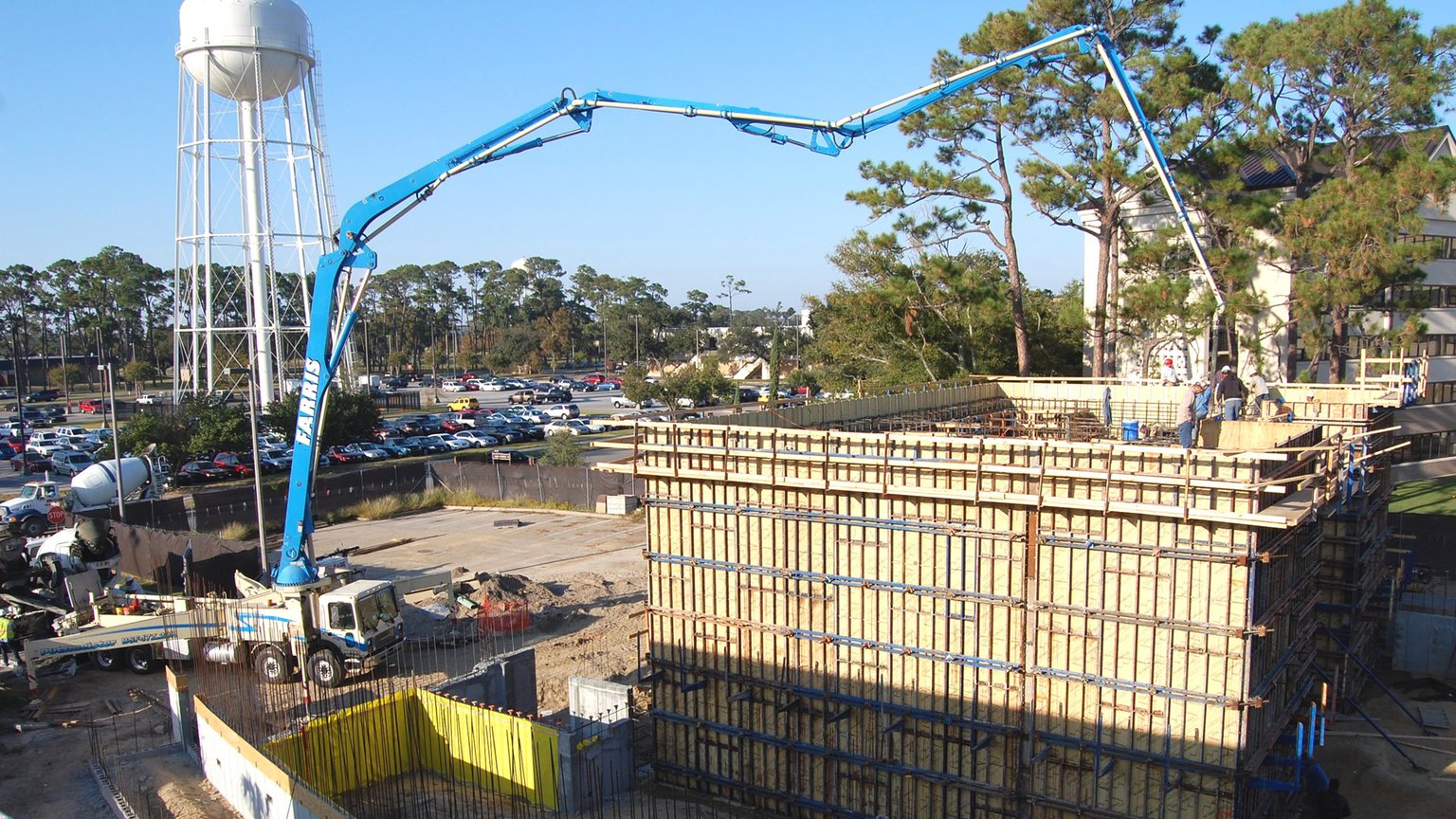 Crew placing and finishing concrete on a construction site