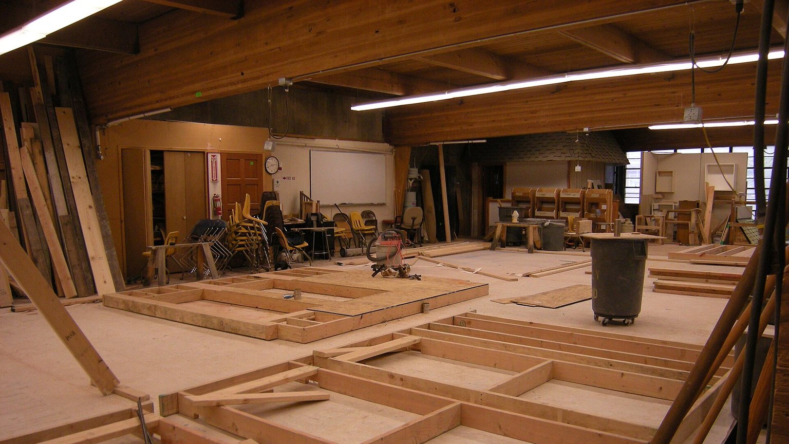 Carpenters framing the wood structure of a new house