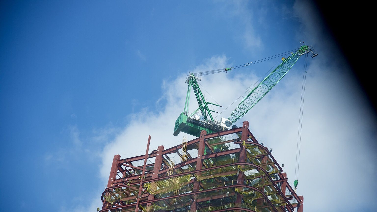 Ironworkers erecting a structural steel frame on a construction site