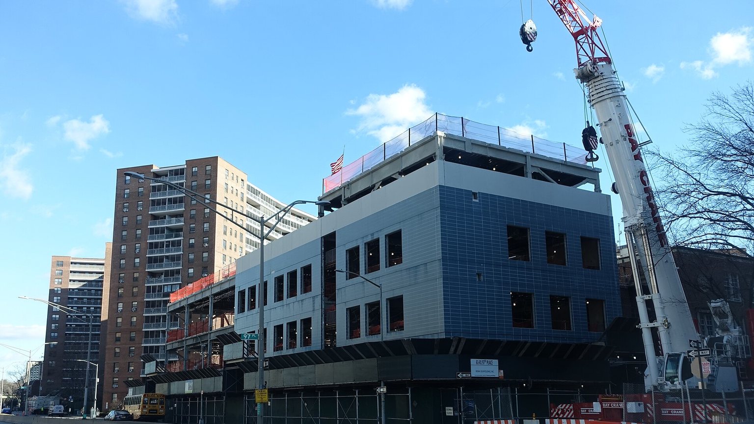 A building under construction with a crane in New York City