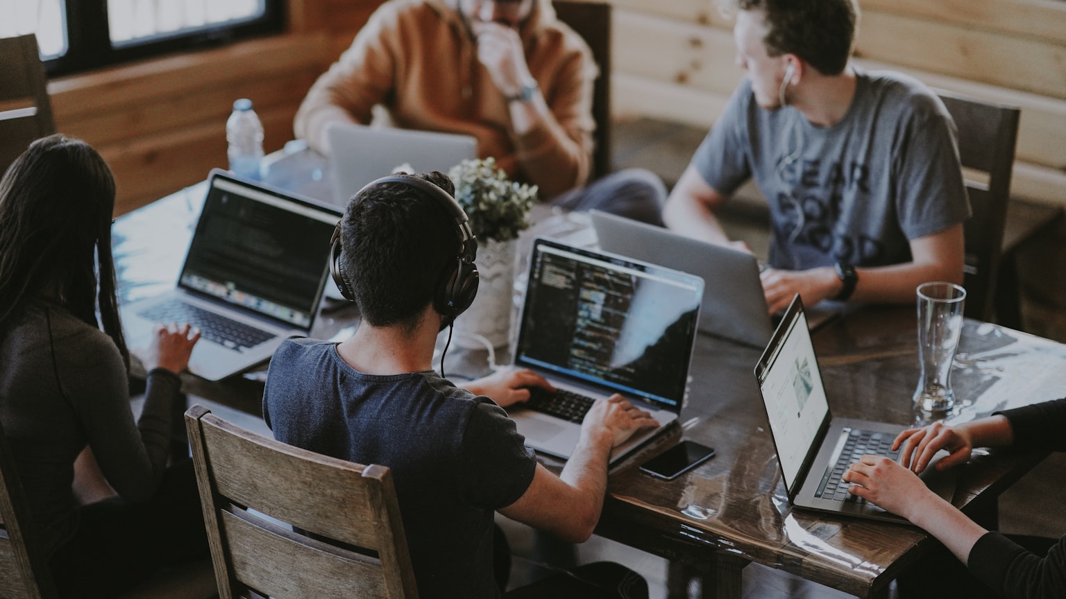 A team working together at laptops around a table